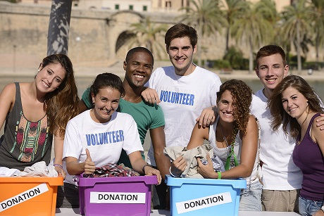 happy and diverse volunteer group smiling outdoors